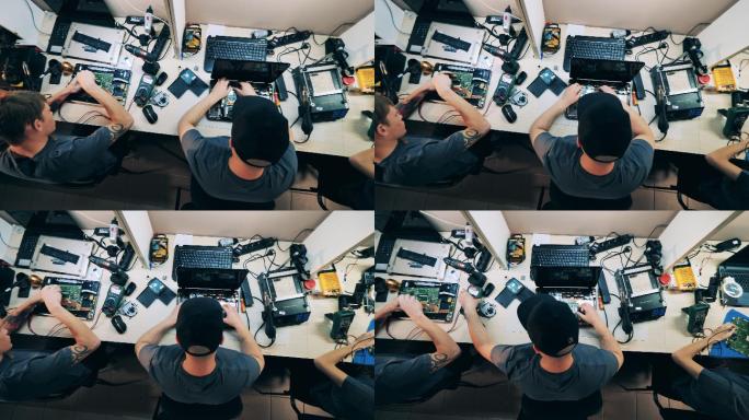 维修人员俯视图手机组装拧螺丝特写修电子产