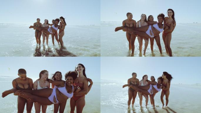 穿着比基尼的不同女人抱着朋友在海边玩。