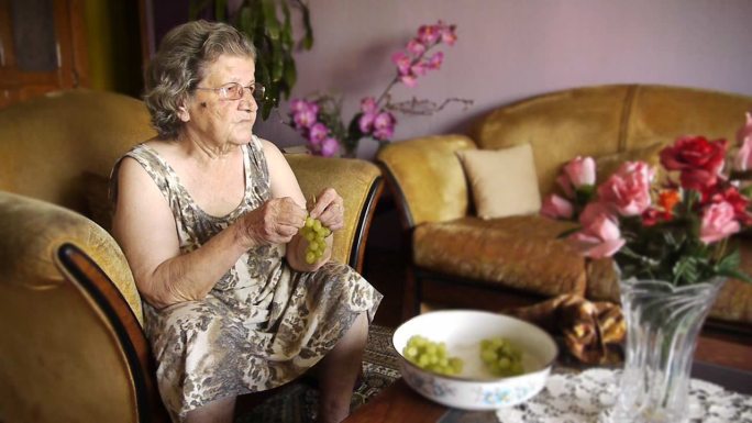 退休妇女在家吃葡萄
