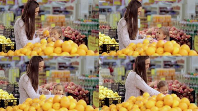 妈妈和小女儿在超市买水果和蔬菜