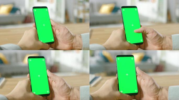 一名男子使用绿色屏幕手机的特写镜头