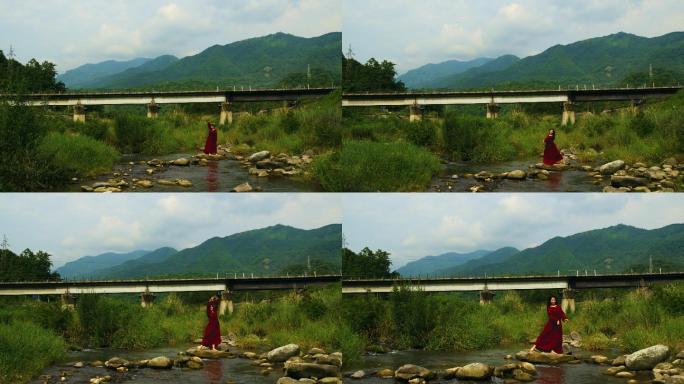 铁路桥下红衣女孩在小溪上翩翩起舞4K航拍