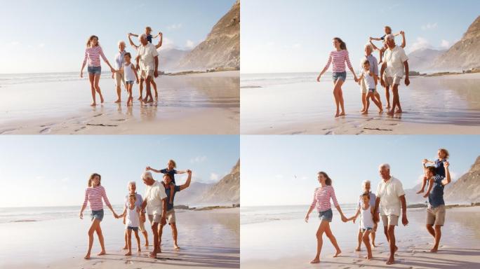 多代人家庭在暑假沿着海滩散步