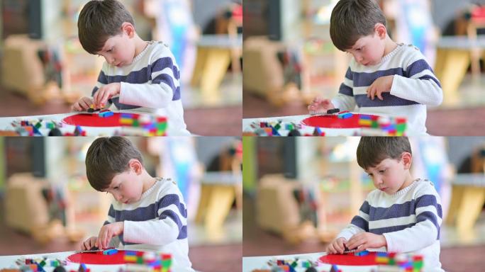 可爱的小男孩在幼儿园玩建筑玩具
