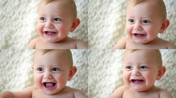 可爱的婴儿笑着露出第一颗牙