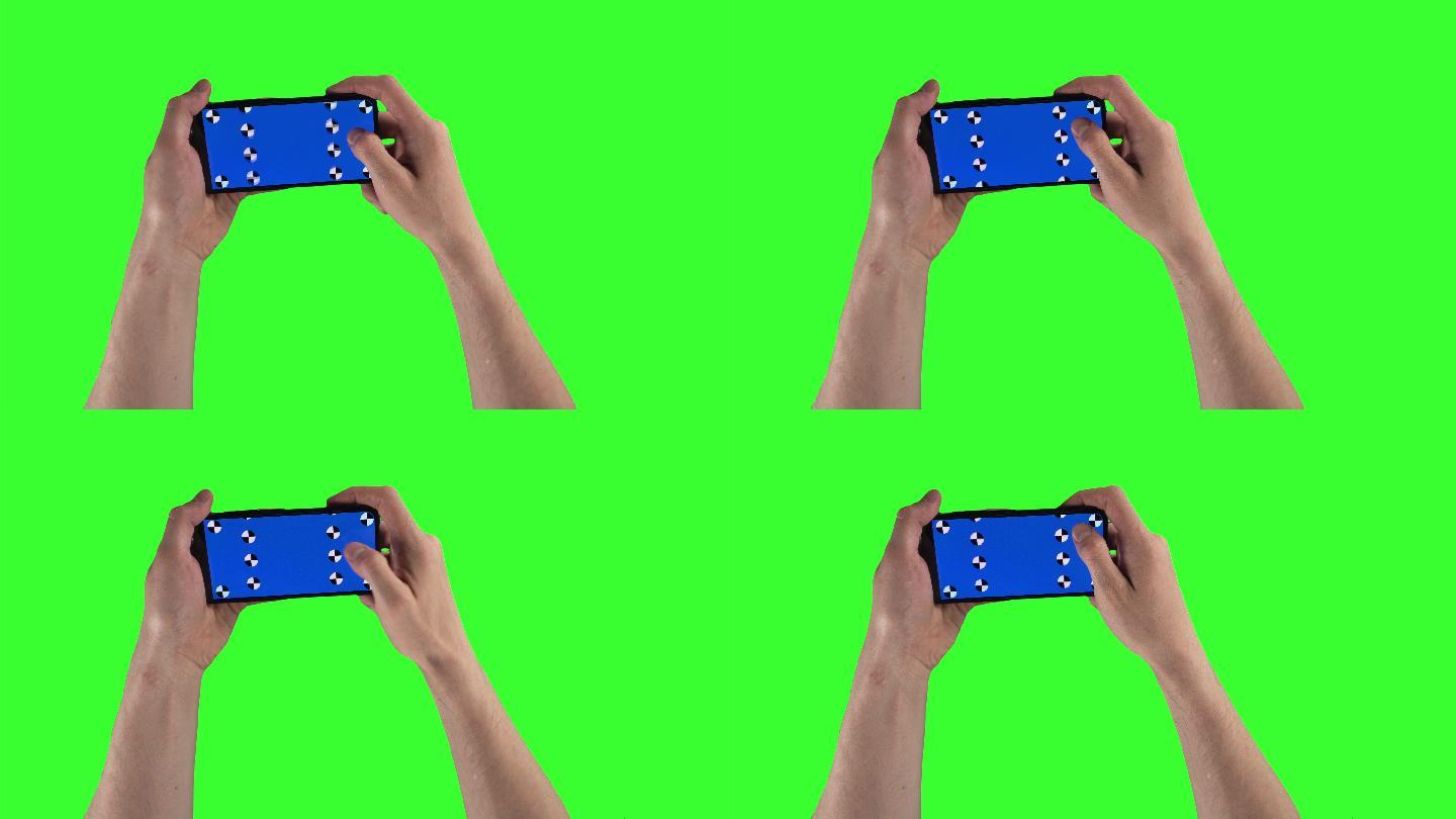 男子双手握着绿色屏幕上的智能手机