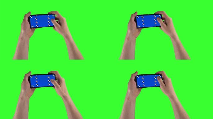 男子双手握着绿色屏幕上的智能手机