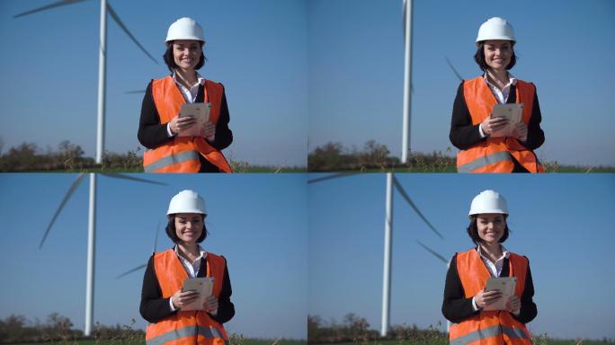 微笑的女工程师站在风电场旁边