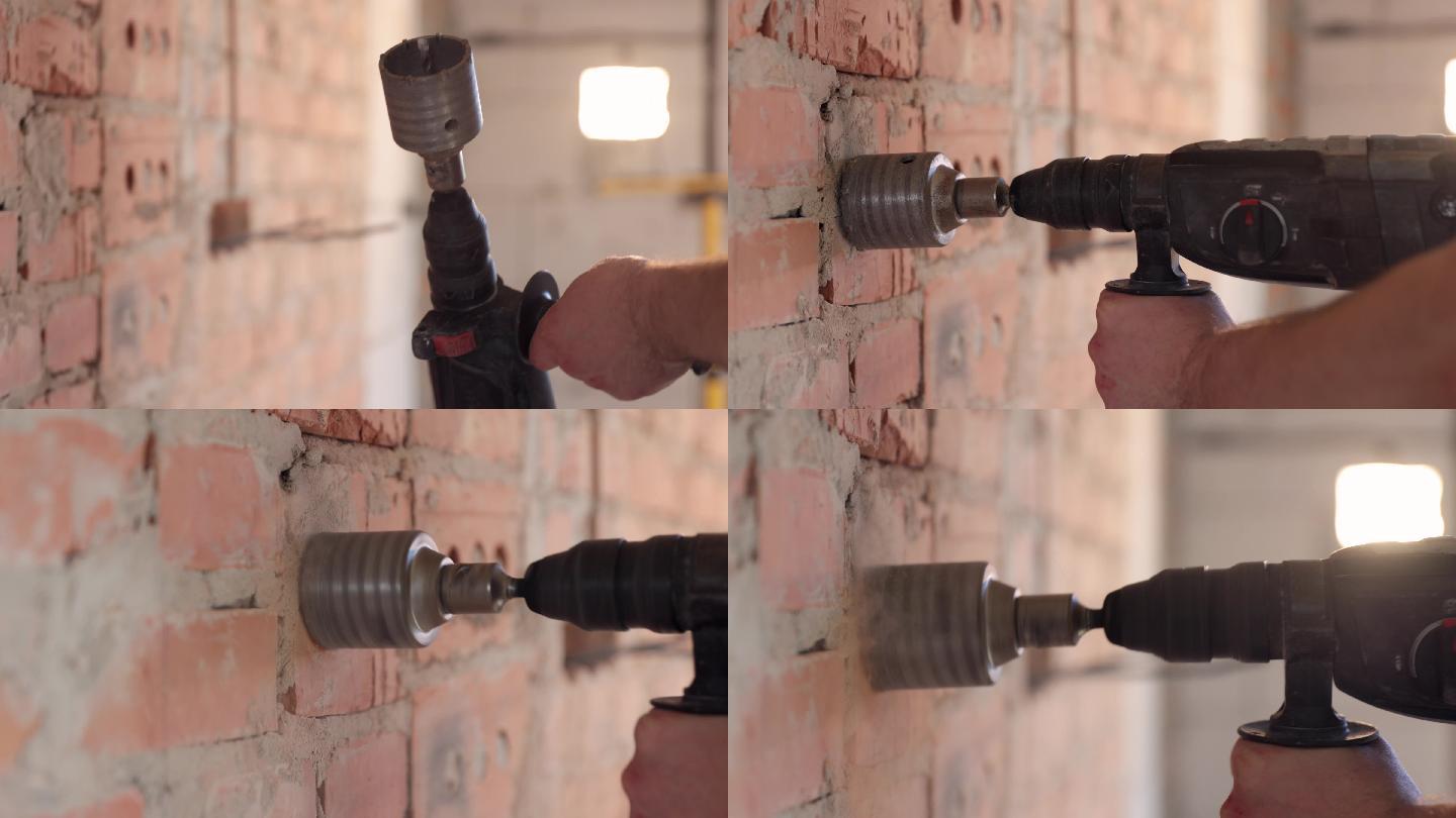 一个建筑工人用一个钻孔机在墙上钻孔。