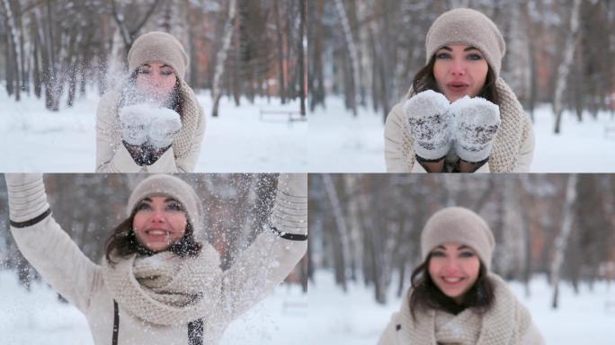 冬日森林里年轻女子吹着手上的雪