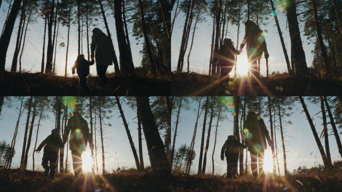一名妇女和一名儿童穿过森林的剪影