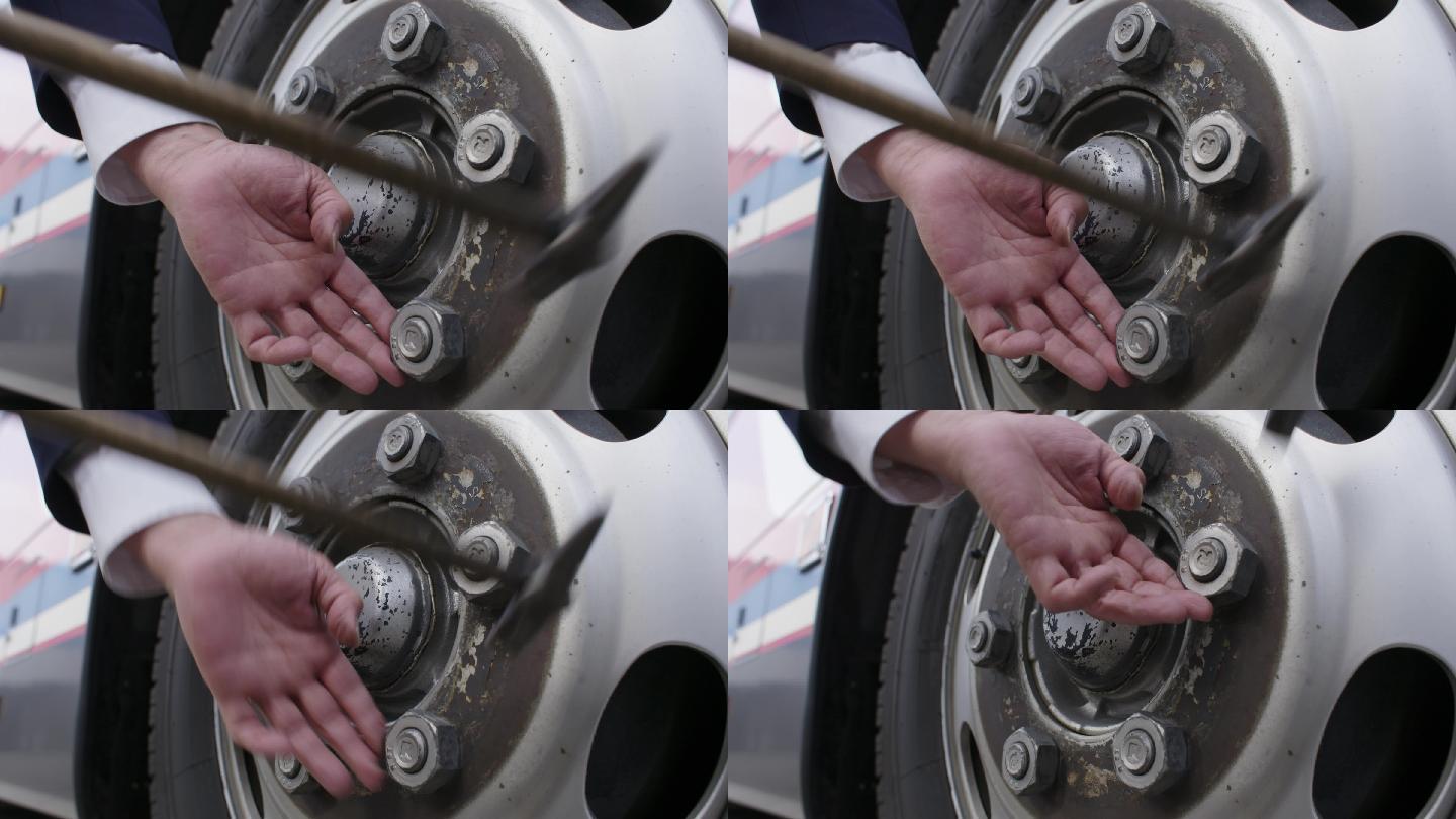 司机检查车轮胎的螺丝