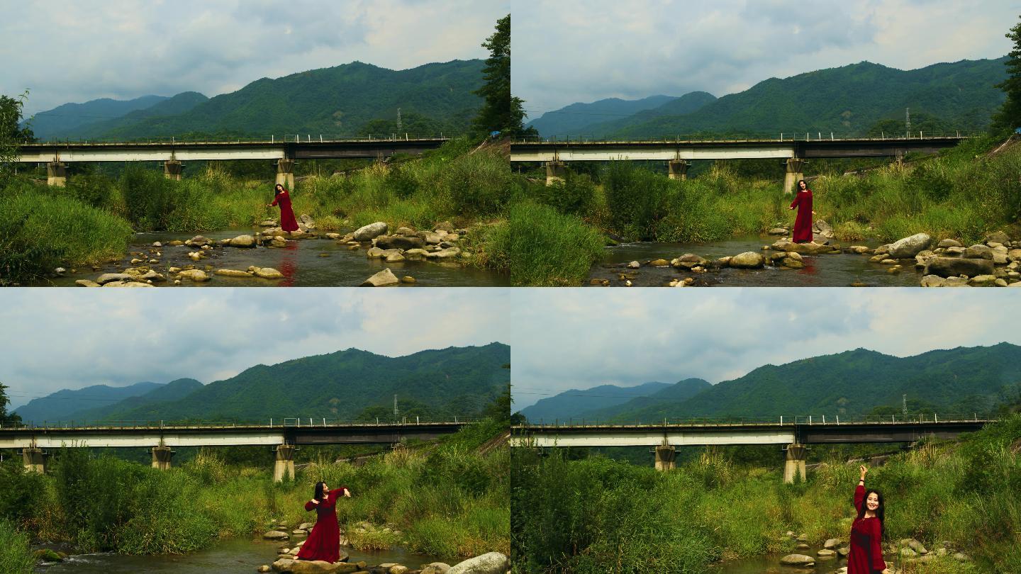 铁路桥下红衣女孩在小溪上翩翩起舞4K航拍