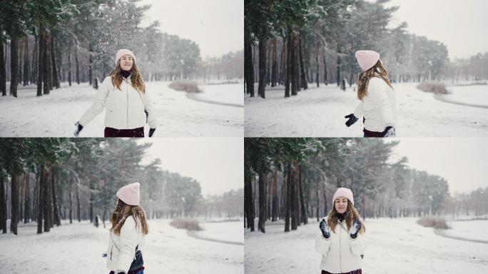 女人把雪扔起来，在雪下旋转