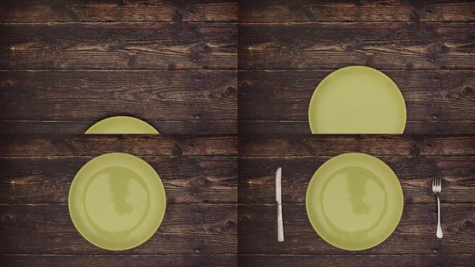 绿色盘子、刀叉在木桌上的停止运动动画