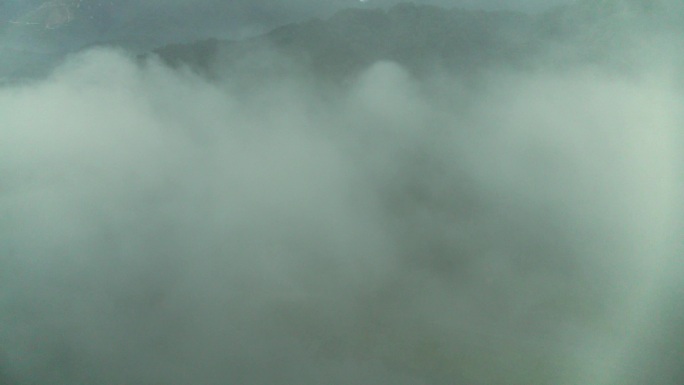 森林里清晨炊烟的山村4K航拍穿过云雾
