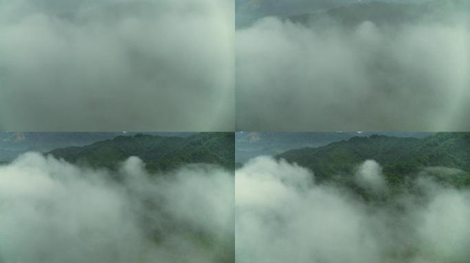 森林里清晨炊烟的山村4K航拍穿过云雾