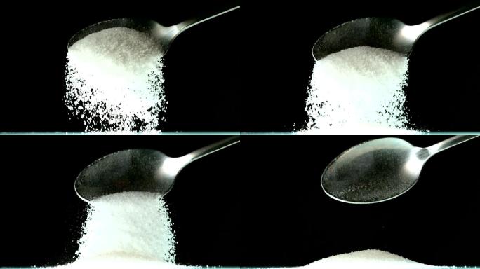用勺子将白糖倒在黑色背景上