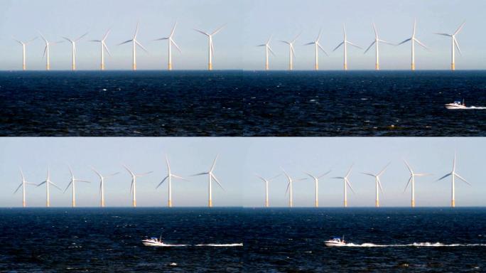在海上风电场涡轮机前面经过的小船