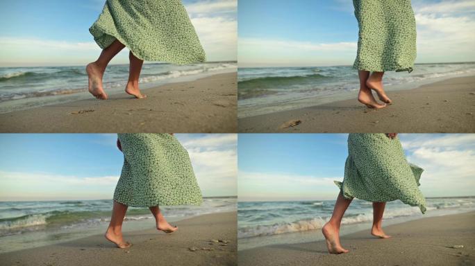 海滩上的年轻女子行走光脚丫赤脚脚步吹海风