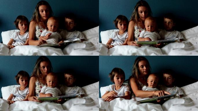 妈妈早上在家里的床上给孩子们读书
