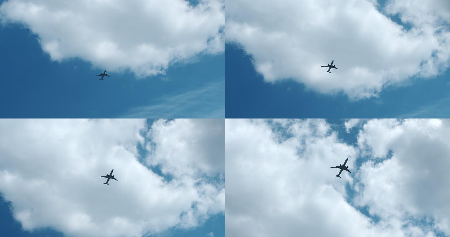 一架客机在蓝天上飞过云层