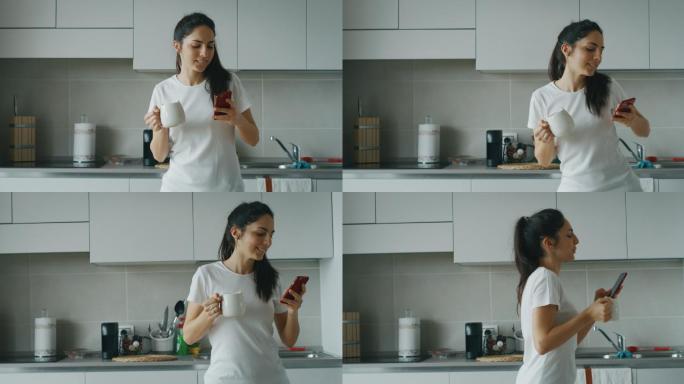 一位年轻女子在厨房喝早茶时使用智能手机