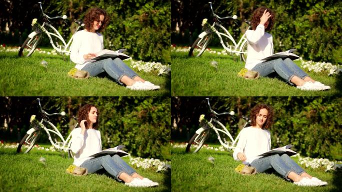女子正坐在公园的草地上看书