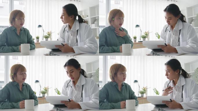 女医生与坐在诊所旁的女患者讨论症状。