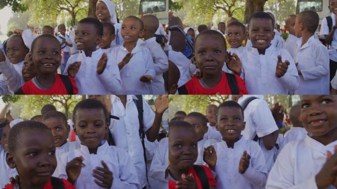 非洲小学生面对镜头拍手微笑