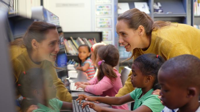 学童在教室里用电脑学习的侧视图