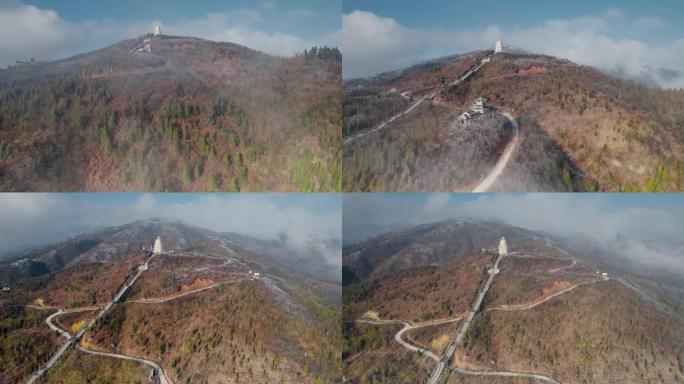 冬季山顶冰雪包裹的高塔和延绵的高山小路