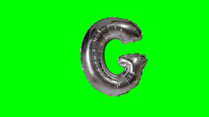 字母G氦银气球漂浮在绿色屏幕上