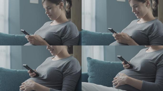 快乐的孕妇用智能手机聊天