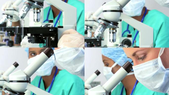 女性研究员通过显微镜观察的特写镜头