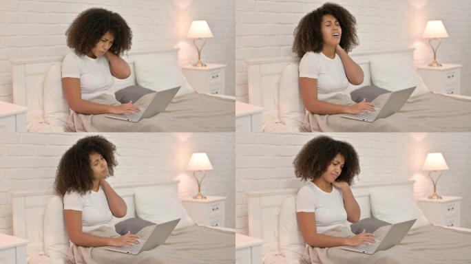 妇女在床上使用笔记本电脑时感到颈部疼痛