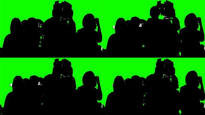 一群摄影师、记者在绿色屏幕上拍摄活动