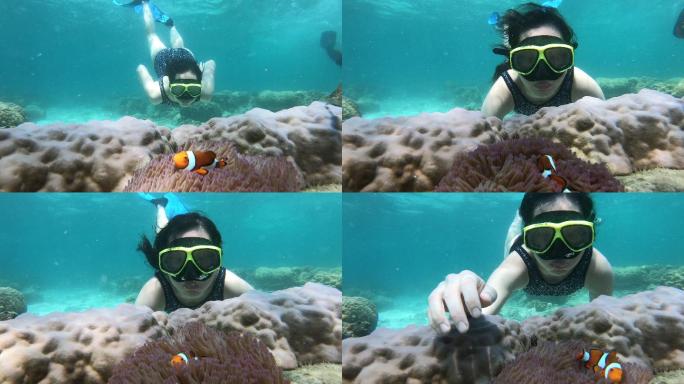 亚洲女子戴着潜水面罩潜入水下