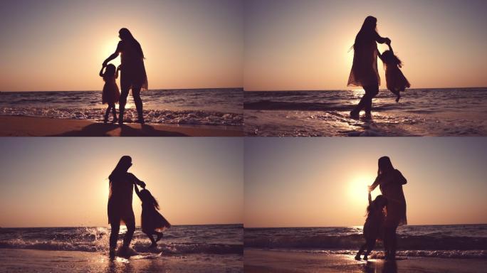 妈妈和小女孩在海滩上跳舞。
