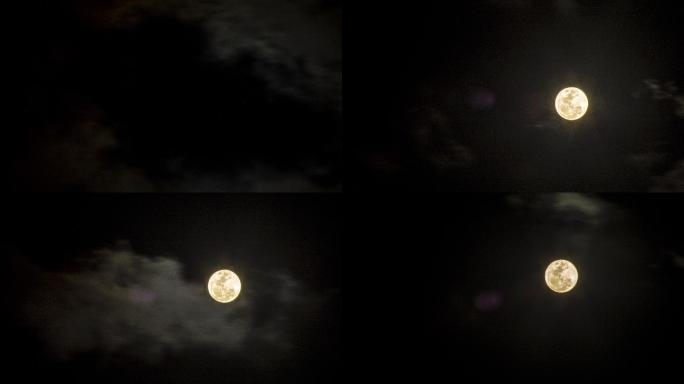 一轮满月在云层中划过天空