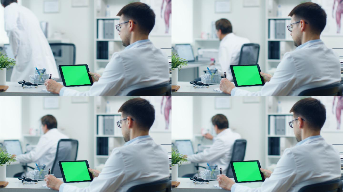 男医生使用绿色屏幕的平板电脑