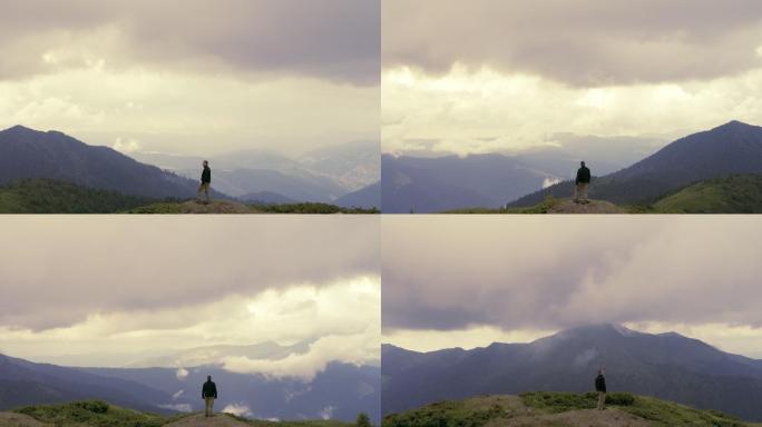 男子站在山上，风景如画