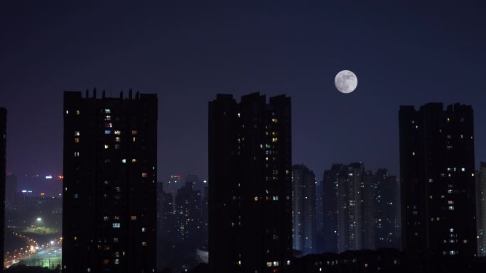 月亮在城市上空升起延时摄影万家灯火