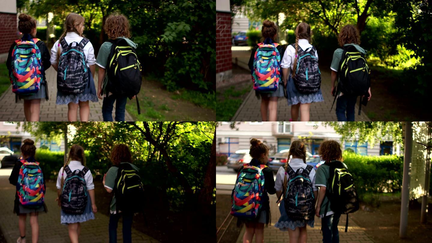 三名学生在城市街道上走路上学。