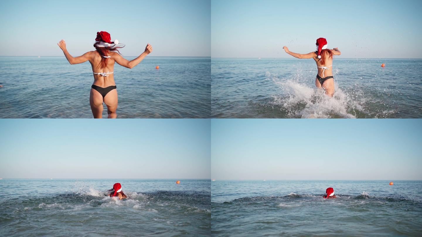 戴着圣诞老人帽的性感女人跑进了大海