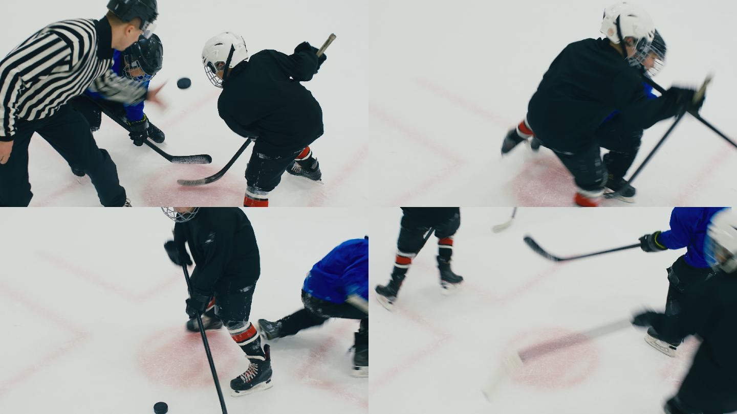 裁判将冰球扔到冰上后，两个男孩争夺冰球