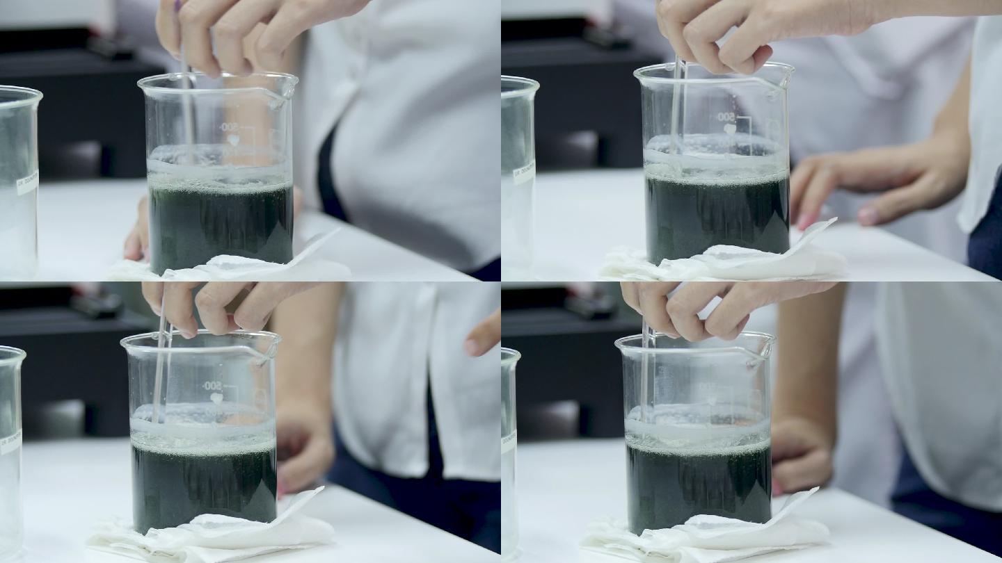 科学家在量杯里搅拌液体