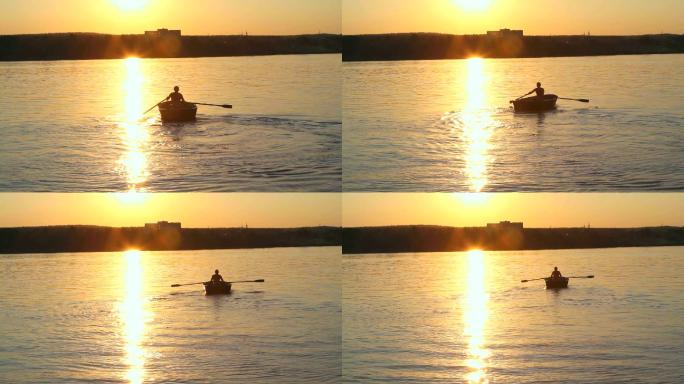 日落时划船的人黄昏湖面