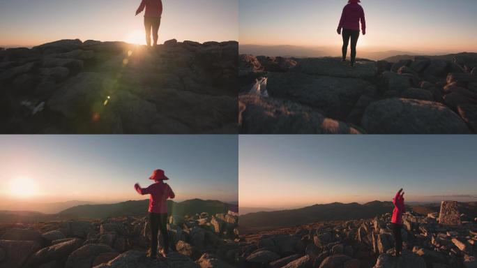 日落时在山上徒步旅行的女人