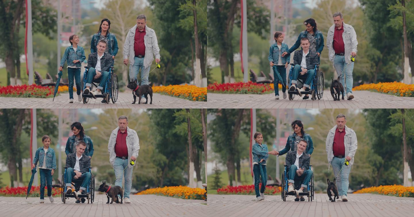 残疾人和家人在公园里散步